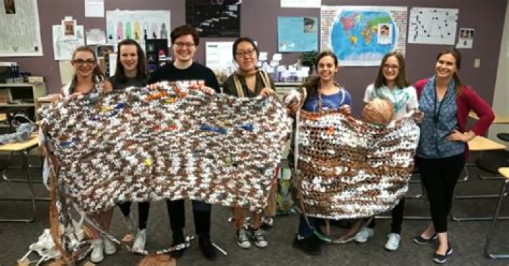 High school students club together to make “plarn” blankets for the homeless